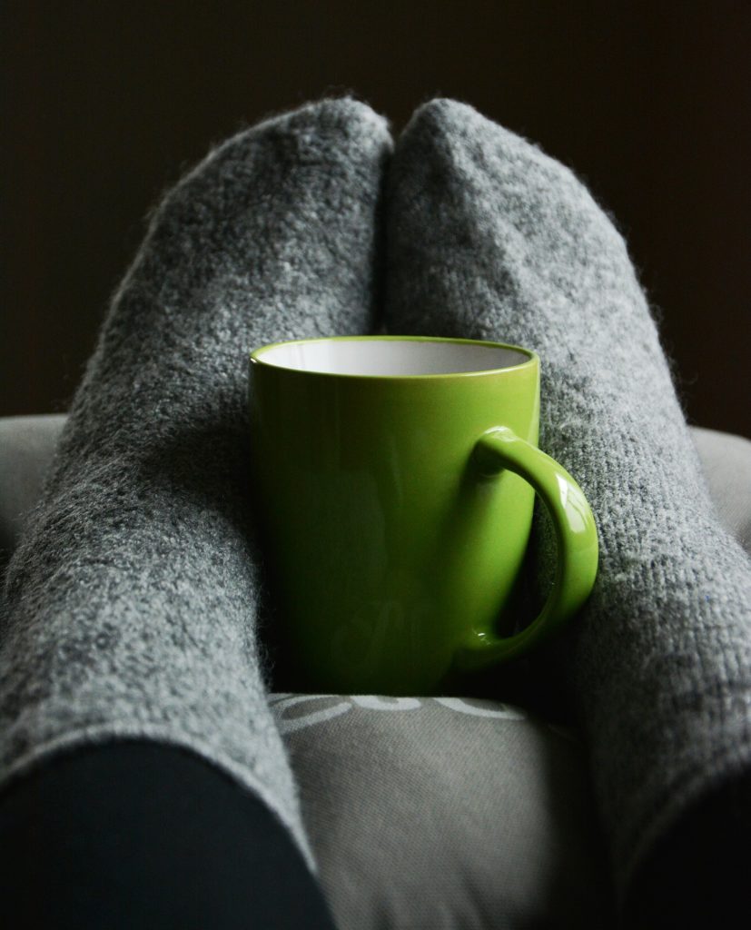 Comfortable in fuzzy socks with a warm mug.
